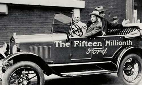 Who is Henry Ford and how did he manage to build an automobile empire?